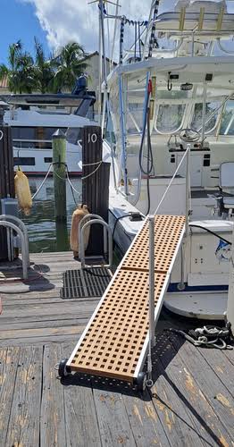 Teak gangway connecting a dock to a yacht